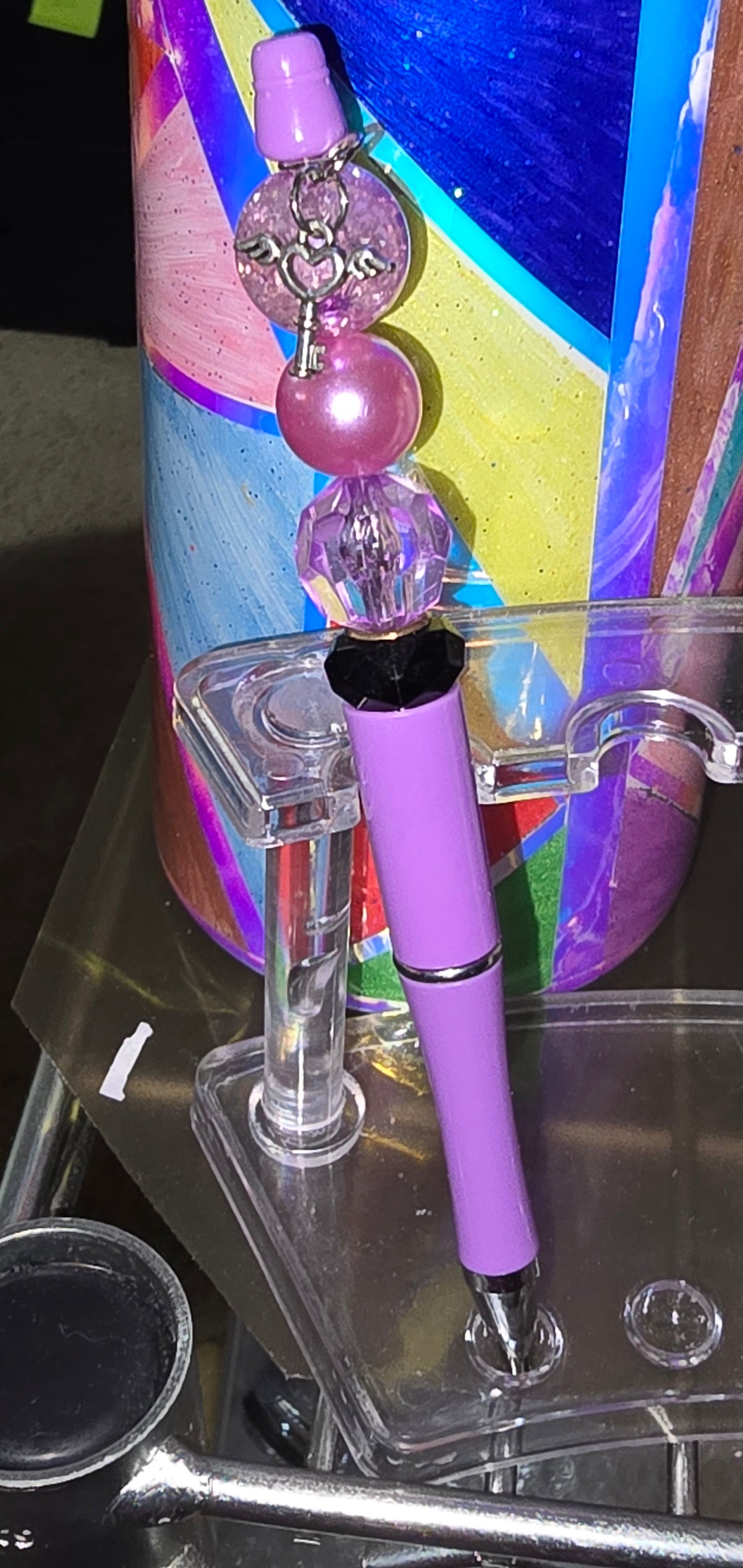 Key with angel wing charm focal pen